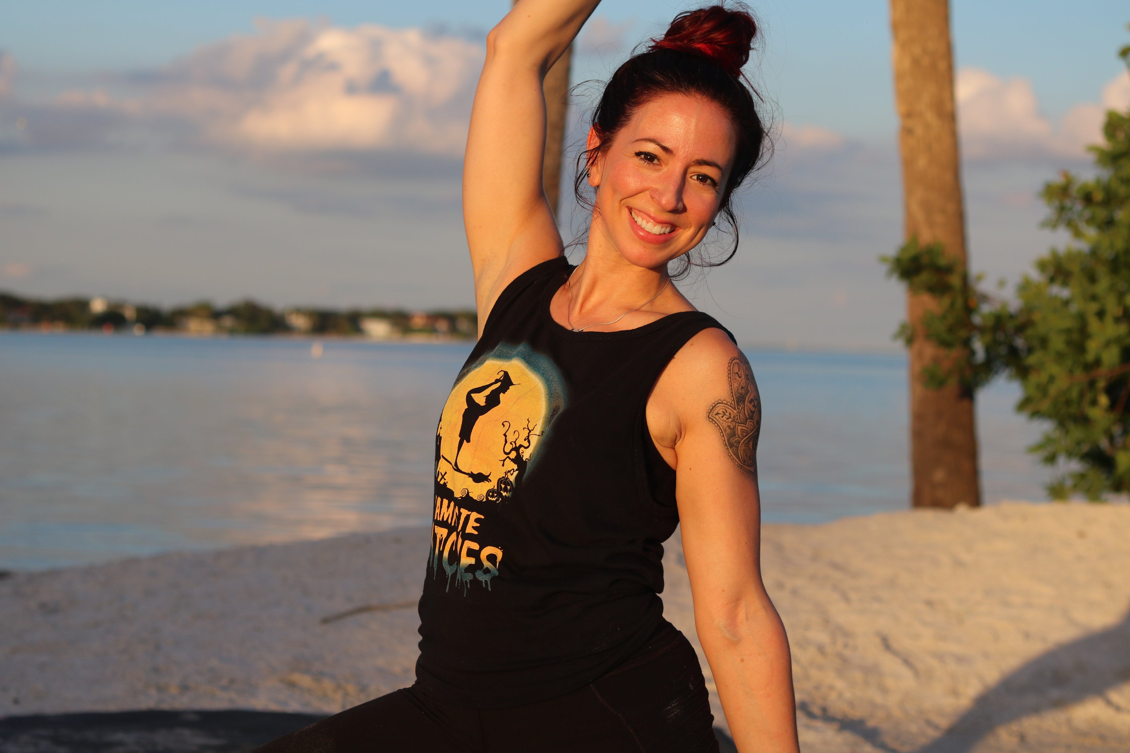 Woman practicing yoga by the beach, St. Pete.